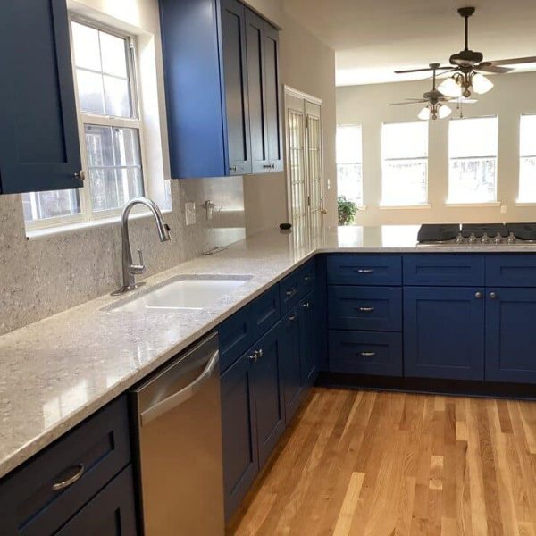 Custom kitchen with quartz counters and navy island built by JCG in West Georgia